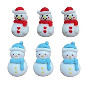 May include: Six small snowman figurines, three with red hats and scarves and three with blue hats and scarves. The snowmen are white with black eyes and mouths and two black buttons.