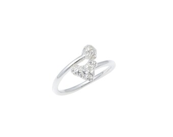 May include: A silver ring with a heart-shaped design featuring small, clear stones.