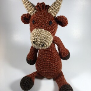 Crocheted stuffed cow with customized story card