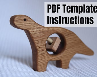 May include: Wooden dinosaur toy with a spinning square block in the middle. The toy is made of light brown wood and has a simple design. PDF Template & Instructions.