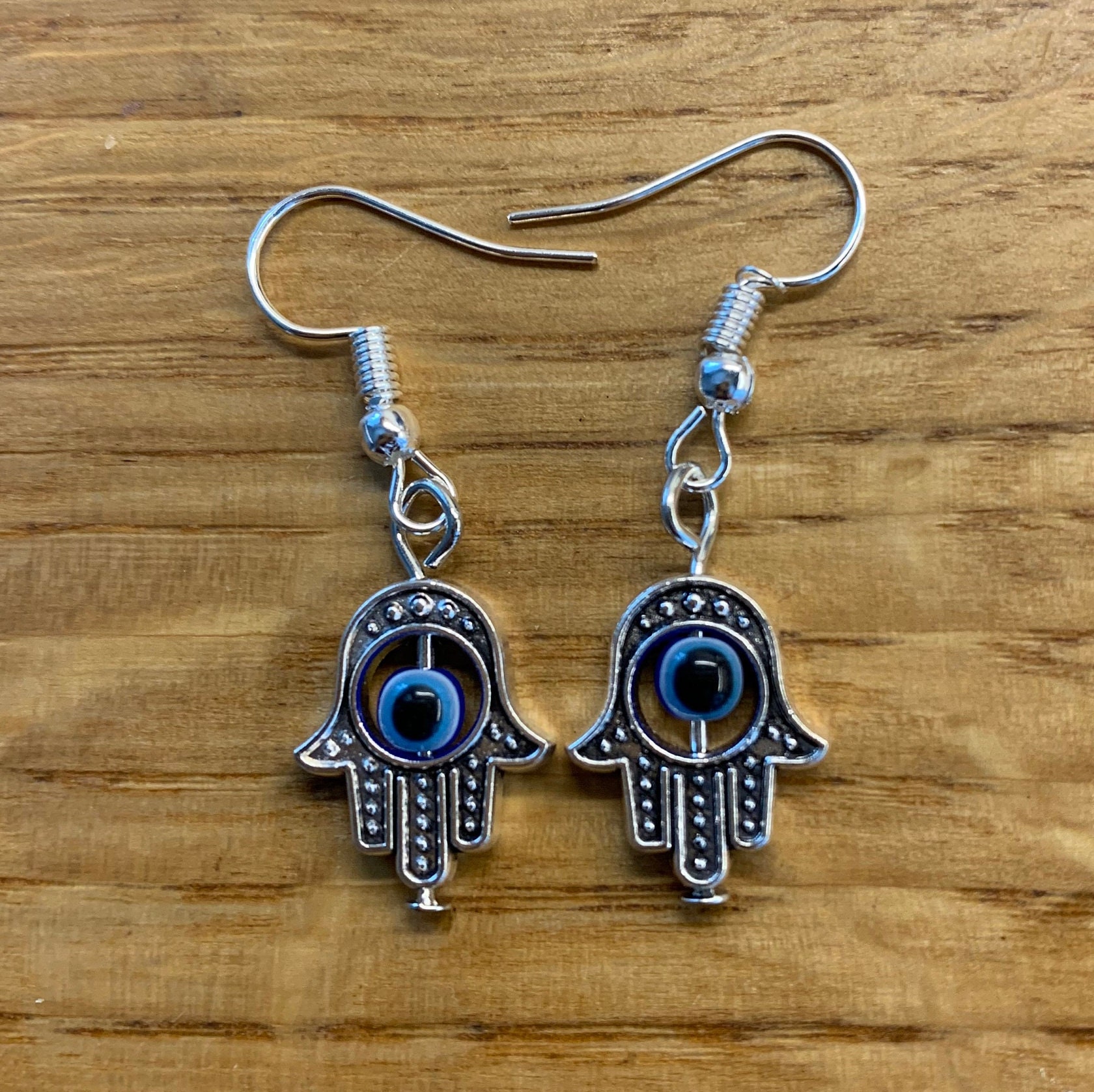 Evil eye hand earrings deals