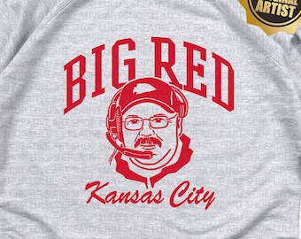 May include: Grey sweatshirt with a red graphic of a man wearing a baseball cap and glasses with the text "BIG RED" and "Kansas City". The text "use 1 colour on grey" is also included on the sweatshirt.