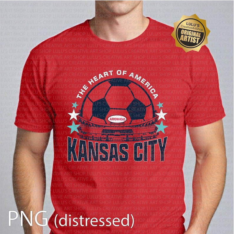 Puede incluir: Camiseta roja con un dise&ntilde;o de bal&oacute;n de f&uacute;tbol, el texto "THE HEART OF AMERICA" y "KANSAS CITY". El dise&ntilde;o incluye estrellas y un logotipo "ARROWHEAD". La camiseta tiene un efecto desgastado y una insignia de "ORIGINAL ARTIST".
