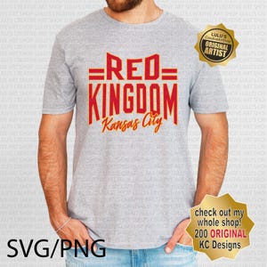 May include: A gray t-shirt with a red and orange graphic that says "=RED= KINGDOM Kansas City". The graphic is in a vintage style font. The t-shirt is being worn by a person. There is a gold star-shaped sticker on the right side of the image that says "LULU'S CreativeArtShop ORIGINAL ARTIST".