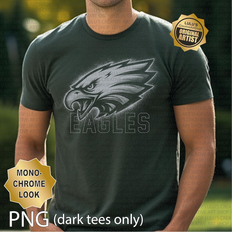 May include: Dark green t-shirt with a monochrome eagle head graphic and the word "EAGLES" underneath. The shirt has a crew neck and short sleeves. The image also includes the text "PNG (dark tees only)" and a gold seal that says "Lulu's CreativeArtShop ORIGINAL ARTIST".
