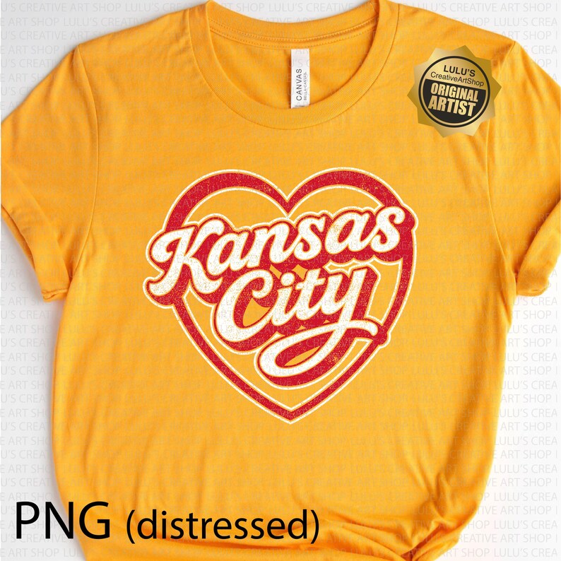 May include: Mustard yellow t-shirt with a distressed red and white heart-shaped graphic that reads "Kansas City". The shirt has a crew neck and short sleeves. A gold sticker with text is on the upper right.