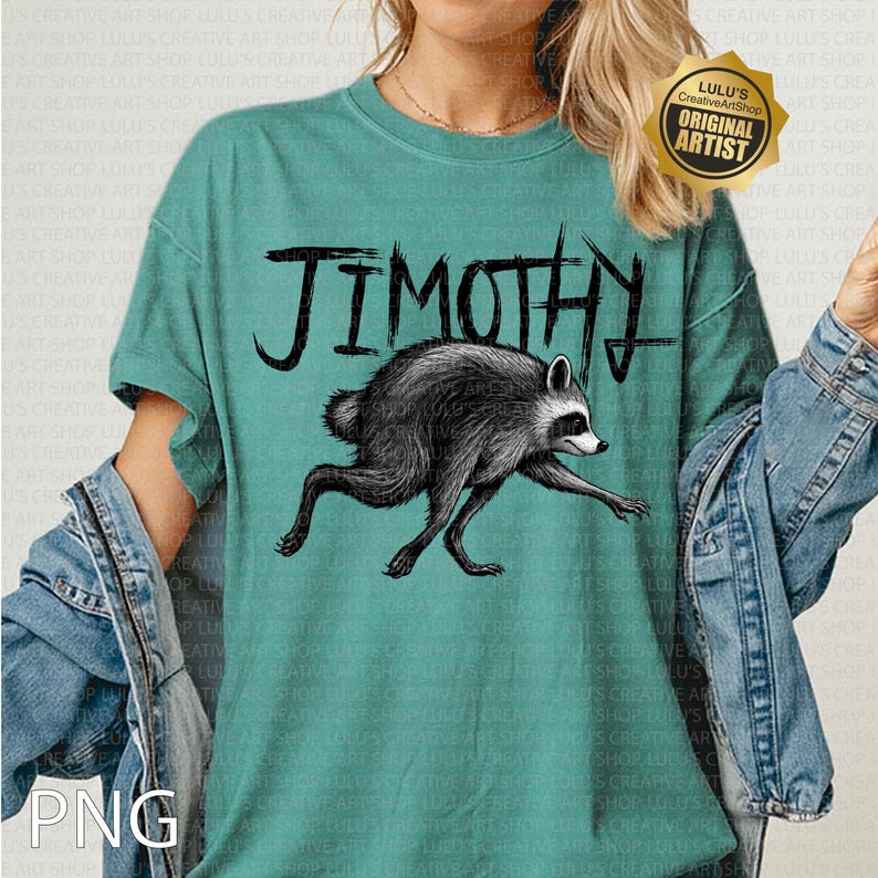 May include: A teal short-sleeve t-shirt featuring a black graphic illustration of a raccoon in a running pose. Above the raccoon, the text JIMOTHY is printed in a bold, hand-drawn black font. The shirt has a crew neckline and a relaxed fit.
