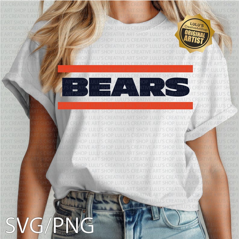 May include: White t-shirt featuring the word "BEARS" in navy blue block letters, with orange horizontal stripes above and below. A gold "ORIGINAL ARTIST" seal is in the upper right corner. The bottom of the shirt is visible.