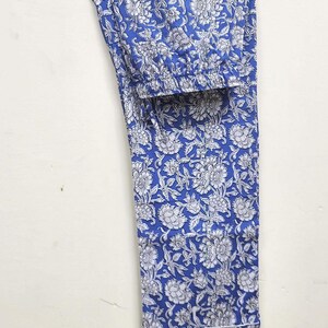 May include: Blue pajama pants with a white floral print.