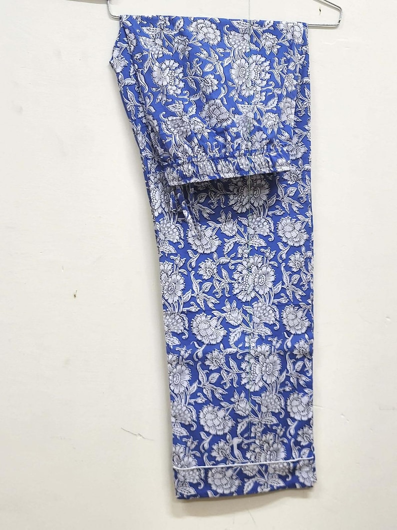 May include: Blue pajama pants with a white floral print.