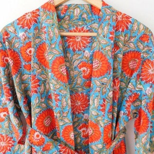 May include: A blue and orange floral print cotton robe with a tie belt.