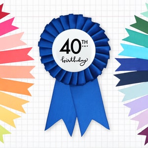 May include: A blue satin ribbon with a white circle in the center that says "40th birthday". The ribbon is tied in a bow and is surrounded by colorful ribbon streamers.