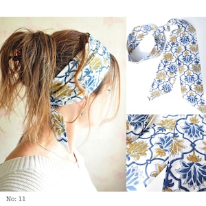 May include: A white headband with a blue and gold floral pattern is tied around a person's hair. The headband is made of fabric and has long, flowing ends. The image also shows a close-up of the fabric's pattern and the text "No: 11".