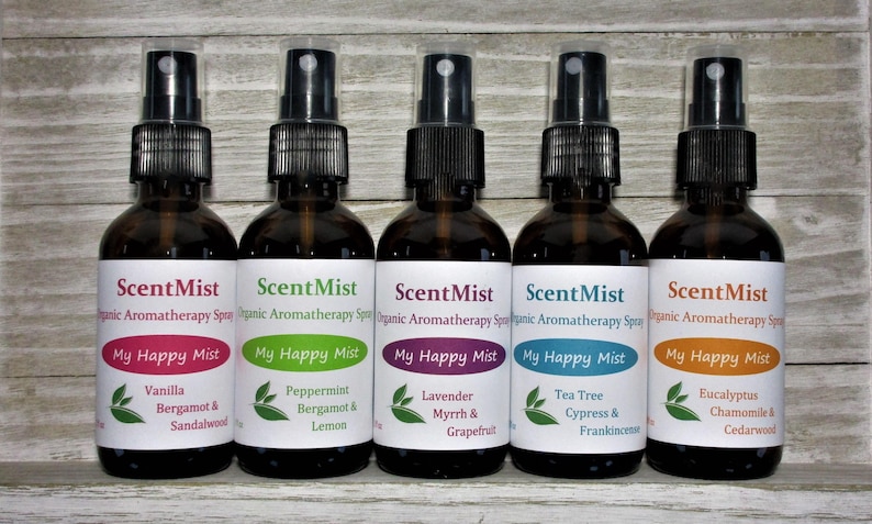 May include: Five brown glass spray bottles of aromatherapy spray, each with a different label color. The labels read "ScentMist" and "My Happy Mist" with various scent names like Vanilla, Peppermint, Lavender, Tea Tree, and Eucalyptus.