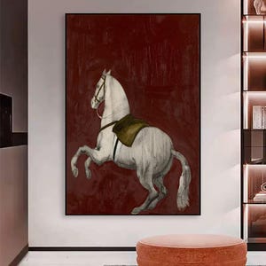 May include: A framed artwork featuring a white horse rearing up against a deep red background. The horse is detailed with a saddle and bridle, and the artwork has a vintage, sketched aesthetic. The piece is a decorative wall art.