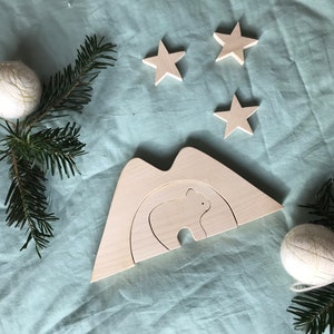 Puzzle little bear in his cave. Solid wood, handmade in the Alps. Mountain, teddy bear.