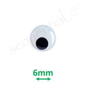 Può includere: Un singolo occhio mobile con un anello esterno bianco e una grande pupilla nera. L'occhio misura 6 mm di diametro, come indicato dal testo e dalle frecce verdi sottostanti. L'occhio è su sfondo bianco.