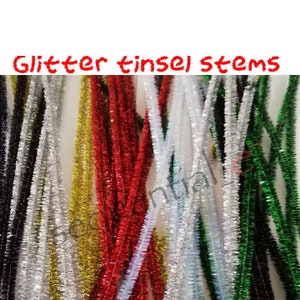 May include: A bunch of glitter tinsel stems in a variety of colours, including red, gold, silver, green, black, and white. The stems are roughly 12 inches long and are ideal for crafting and decorating.