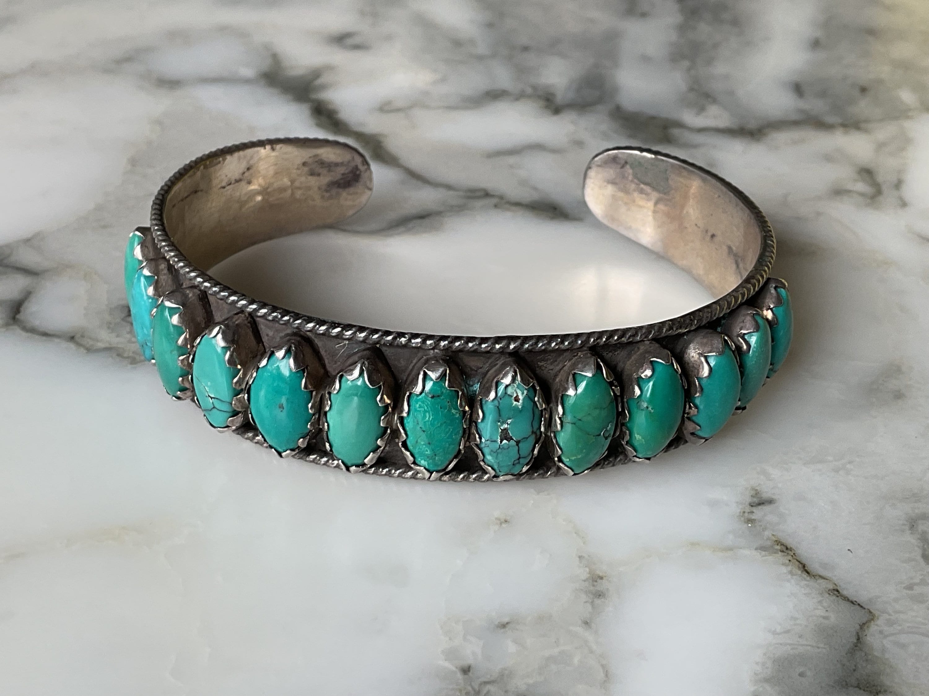 A fantastic Native American Navajo old pawn coin silver and turquoise multi stone cuff bracelet.