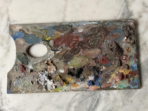 A delightful antique early 20th century hardwood artist’s oil paint mixing palette.