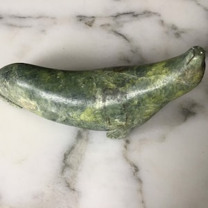 A charming vintage Inuit greenstone carving of a seal.