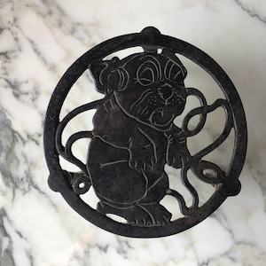 Charming vintage cartoon cast iron trivet