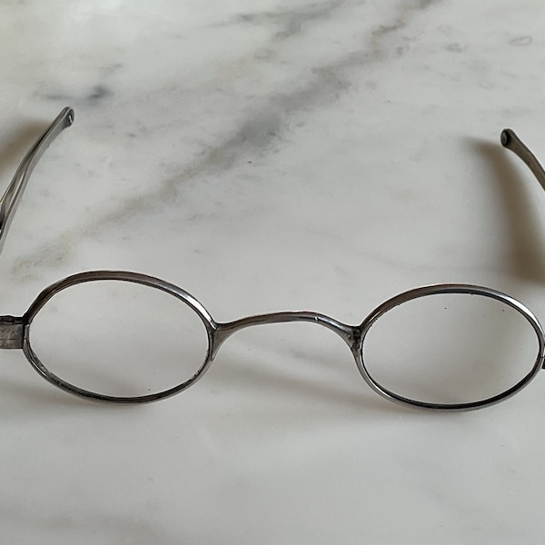A fantastic pair of late Georgian hallmarked sterling silver folding arm glasses.