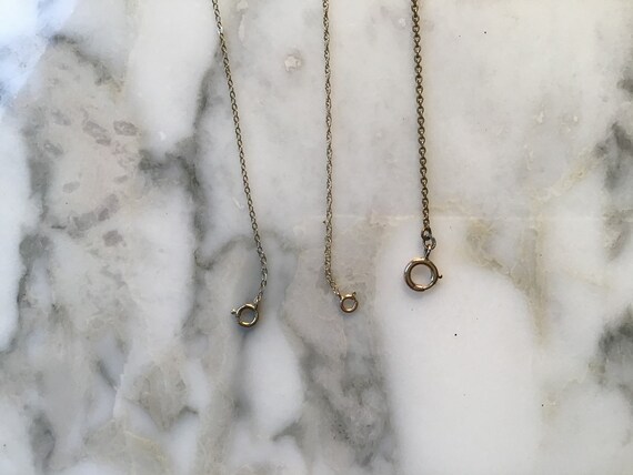 Three 9 carat gold necklace chains.
