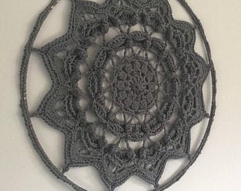 May include: A large, gray crocheted mandala wall hanging with a circular wooden frame.