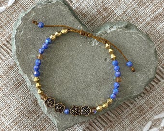 Handmade adjustable slipknot beaded bracelet, gold tone beads, gold tone flowers, faceted purple beads, Brazilian cord, 6-7in wrist
