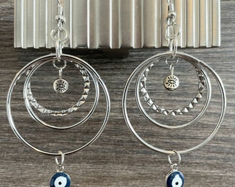 Unique one of a kind handmade earrings with clear quartz gemstones and evil eye charms