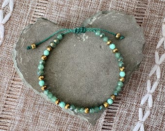 Handmade adjustable woven slip knot bracelet, gold tone beads, faceted glass sea foam green and white beads, Brazilian cord, 6-7in wrist