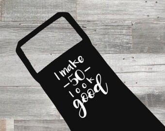 May include: Black apron with white text that reads "I make 50 look good".