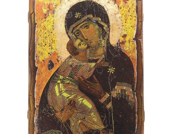 May include: A religious icon depicting a mother and child, painted on a wooden panel. The artwork features a gold halo, with the figures in dark robes and intricate details. The wooden frame has a distressed, aged appearance.