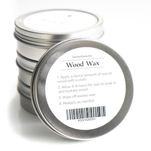 May include: A silver tin with a white label that reads "Instructions for Wood Wax" and lists instructions for applying the wax. The label also includes a barcode and the text "X002VQ8SX3".