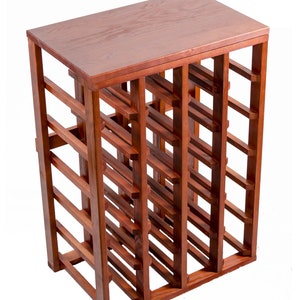 May include: A wooden wine rack with a table top, holding 24 bottles. The rack is made of solid wood and has a spring cherry finish. Pictured is 24 Bottle Table Top.