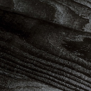 May include: Close-up of a dark wood grain surface with a smooth, polished finish.