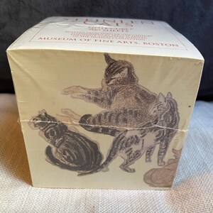 May include: A square note cube containing 700 sheets, wrapped in clear plastic. The top and front feature brown ink illustrations of cats by Théophile-Alexandre Steinlen. Text reads: Steinlen Cats, Note Cube, 700 Sheets, Museum of Fine Arts, Boston.