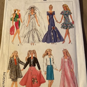 May include: Simplicity sewing pattern number 9334 for making doll clothes. The pattern includes instructions for making eight different outfits for a doll, including a wedding dress, a formal gown, a casual dress, a jacket, a skirt, a sweater, a dress, and a robe. The pattern is for one size.