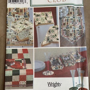 May include: A Simplicity Christmas Club pattern featuring various holiday-themed sewing projects. The pattern includes images of placemats, table runners, and decorative items. The color palette includes red, green, and beige.