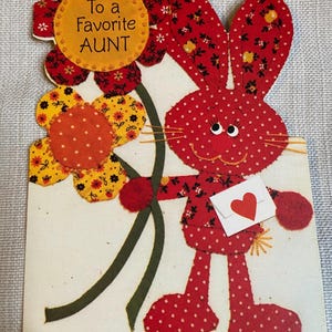 May include: A white ceramic mug with a black handle and the text "But First, Coffee" in a black, bold font. The mug is on a white surface. The mug is approximately 4 inches tall.