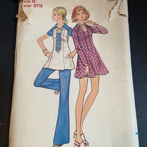May include: A Butterick 5815 sewing pattern envelope for size 8 with a 31.5 inch bust. The illustration shows two outfits: a white tunic with blue trim and blue flared pants, and a long-sleeved purple dress with a small white floral pattern.