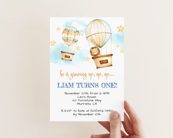 May include: A blue and yellow hot air balloon birthday invitation with a lion in the basket. The invitation says "he is growing up, up, up... Liam turns one!" and includes details for the party, including the date, time, location, and RSVP information.