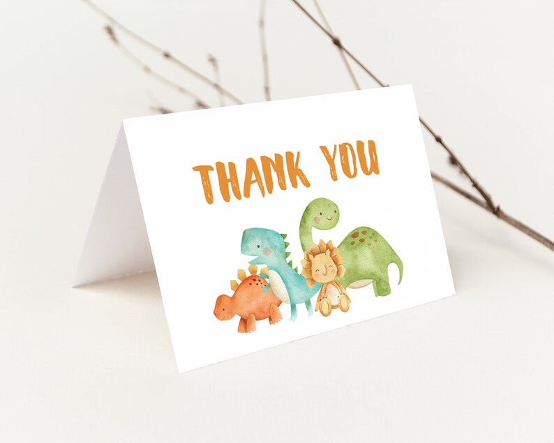 May include: Thank you card with a watercolor illustration of four dinosaurs. The dinosaurs are green, blue, orange, and yellow. The card has the text "Thank You" in orange.