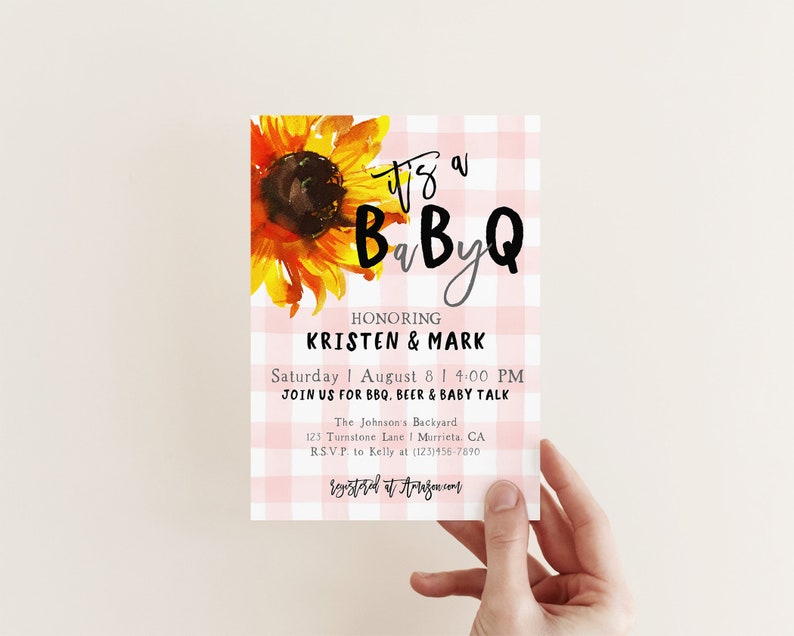 May include: Pink and white gingham baby shower invitation with a sunflower illustration. The text reads "It's a BaByQ honoring Kristen & Mark, Saturday August 8 | 4:00 PM, Join us for BBQ, Beer & Baby Talk, The Johnson's Backyard, 125 Turnstone Lane | Murrieta, CA, RSVP to Kelly at (123)456-7890, registered at Amazon.com".