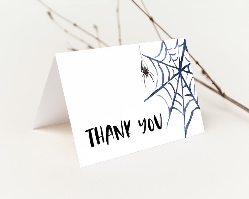 May include: A white thank you card with a black spider and blue spider web illustration. The text "THANK YOU" is written in black.