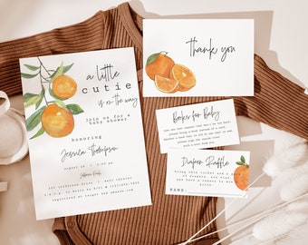 May include: Orange themed baby shower invitation set with a watercolor illustration of oranges on a branch. The invitation reads "a little cutie is on the way". The set also includes a thank you card, a book request card, and a diaper raffle card.