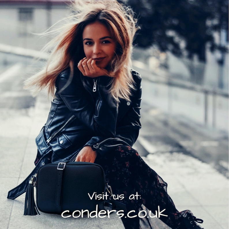 May include: A black leather crossbody bag with a long tassel. The bag has a flap closure with a buckle and an adjustable strap. Visit us at: conders.co.uk