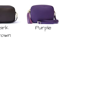 May include: Two small leather crossbody bags. The bag on the left is dark brown and the bag on the right is purple.