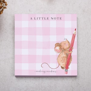 May include: Pink gingham notepad with the text "A LITTLE NOTE" at the top. A watercolour illustration of a mouse holding a red pencil is on the right side. The words "making meadows" are written in cursive at the bottom.